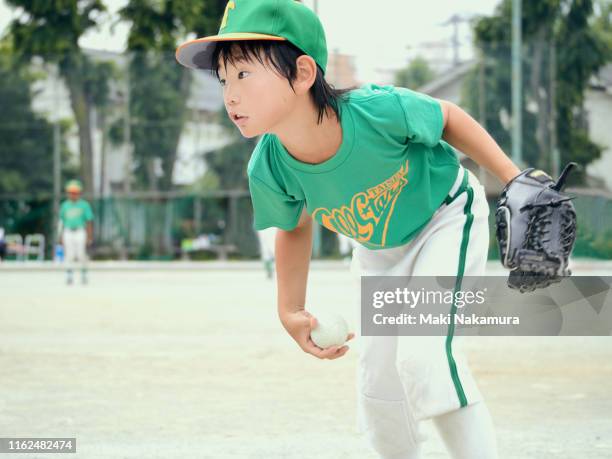 the boy is practicing baseball seriously. - i love teen boys stock-fotos und bilder