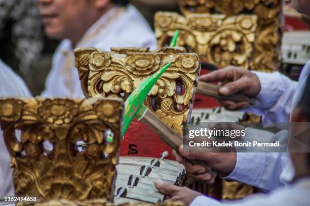 balinese man playing traditional music - gamelan stock pictures, royalty-free photos & images