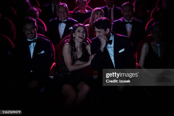 couple laughing while enjoying opera amidst crowd - theatrical performance imagens e fotografias de stock