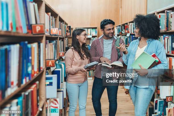 small group of students in the library - public library stock pictures, royalty-free photos & images