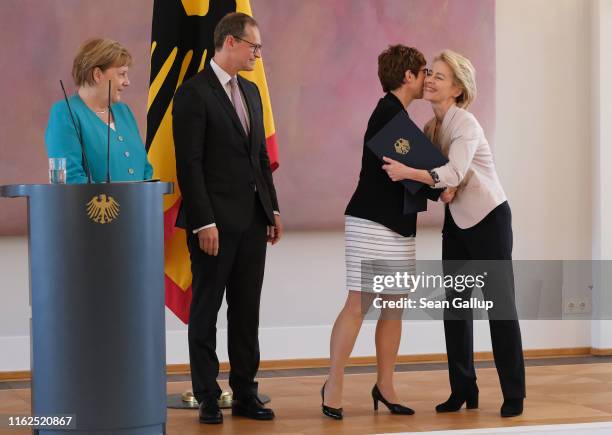 New German Defense Minister Annegret Kramp-Karrenbauer receives an embrace from outgoing Defense Minister Ursula von der Leyen at the appointment...