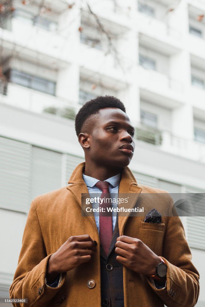 Young black South African man wearing a coat outdoors