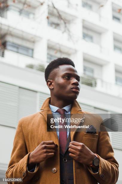 Young black South African man wearing a coat outdoors