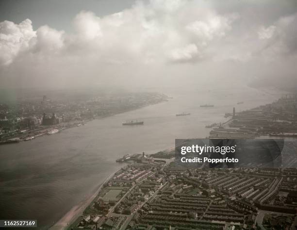 Aerial view of the River Mersey with the City of Liverpool on the left and the towns of Birkenhead and Wallasey on the right, England, July 1958.