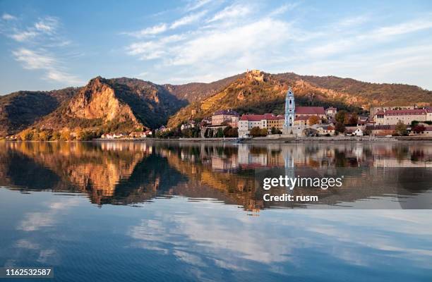 autumn evening view of durnstein old town with reflection in danube, wachau valley, austria - dürnstein stock pictures, royalty-free photos & images