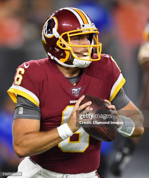 Quarterback Josh Woodrum of the Washington Redskins looks for an open receiver in the fourth quarter of a preseason game against the Cleveland Browns...