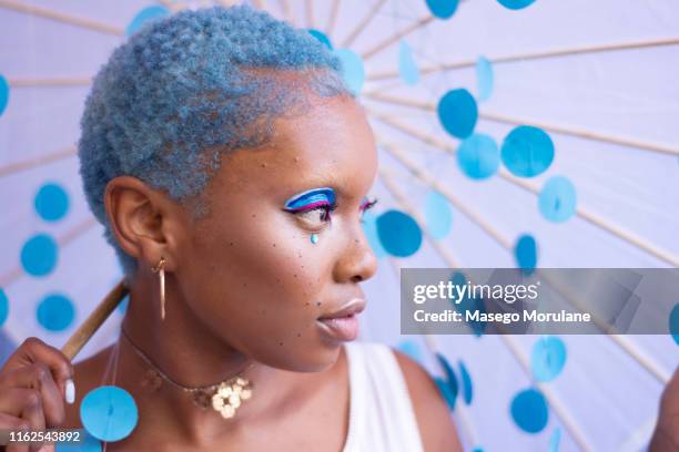 a woman with blue hair - blue hair stock pictures, royalty-free photos & images