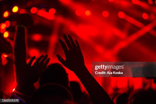 enjoying at music festival. - silhouette auditorium stock pictures, royalty-free photos & images