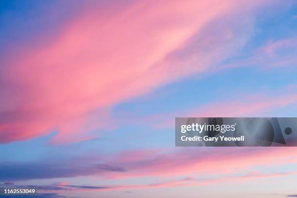 pink clouds at sunset - pink hat stock-fotos und bilder