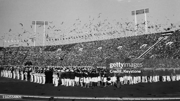 Pigeons are released from the stadium during the opening ceremony at the National Stadium for the XVIII Summer Olympic Games on 10th October 1964 at...