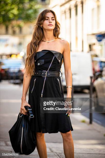 Clara Berry, wearing a black decorated dress and black bag, is seen outside Jean Paul Gaultier show during Paris Fashion Week - Haute Couture...