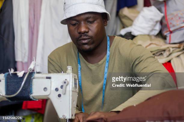 African male tailor with sewing machine