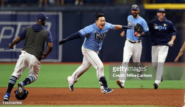 Ji-Man Choi of the Tampa Bay Rays is mobbed by teammates after his walk-off single in the ninth inning of a baseball game against the Detroit Tigers...