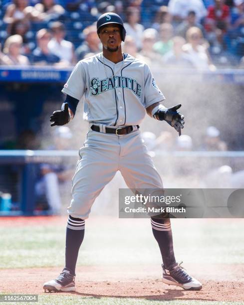 Keon Broxton of the Seattle Mariners celebrates scoring against the Toronto Blue Jays in the ninth inning during their MLB game at the Rogers Centre...