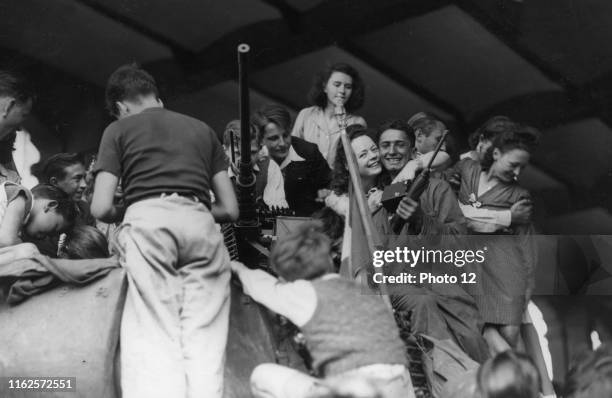 Scene of cheering crowd among French patriots in Paris, during the Liberation World War II Liberation of Paris.