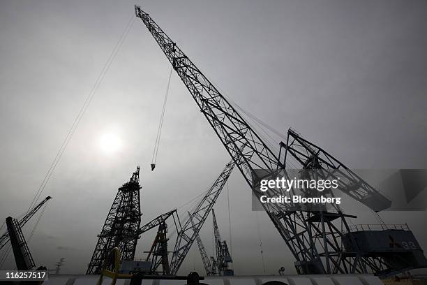 Cranes stand at Mitsubishi Heavy Industries Ltd.'s Honmoku plant in Yokohama city, Kanagawa prefecture, Japan, on Wednesday, June 15, 2011. Nippon...