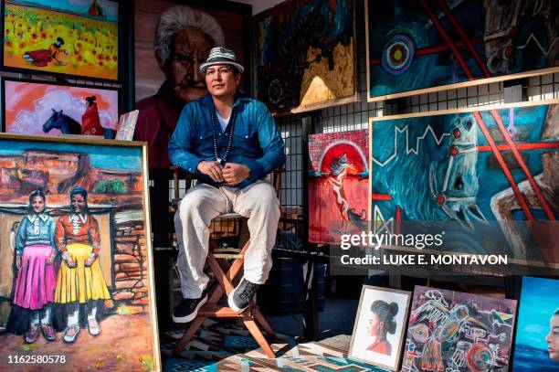Christian Bigwater of Gallup New Mexico, poses for a portrait during the 98th annual Santa Fe Indian Market, the largest market of it's kind hosts...