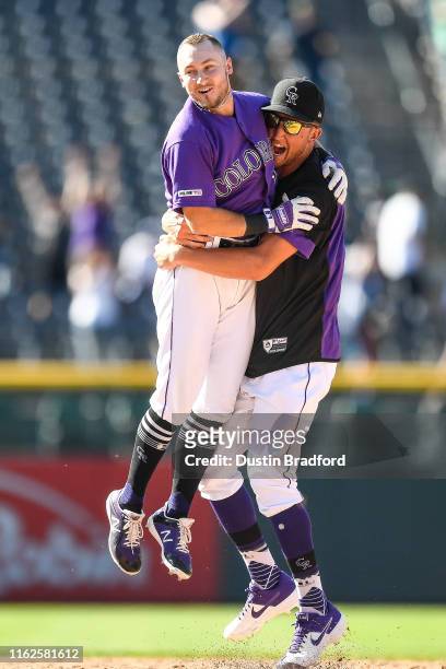 Garrett Hampson of the Colorado Rockies celebrates with Kyle Freeland after Grant's 10th inning walk-off sacrifice single to defeat the Miami Marlins...