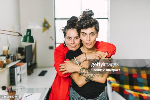 portrait of affectionate homosexual couple at home - lgbtqia culture stock pictures, royalty-free photos & images