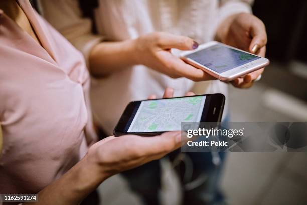 young girls using phone on their way to school - taipei map stock pictures, royalty-free photos & images