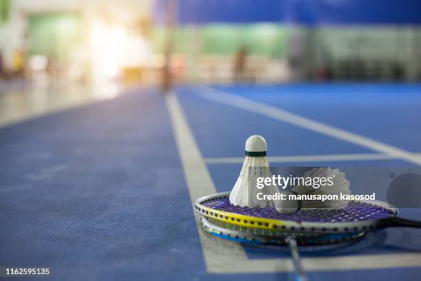 close up shuttlecocks on racket bad mintons at badminton courts with players competing - fjäderboll bildbanksfoton och bilder