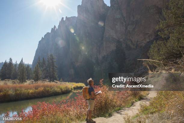 mann nutzt karte auf einem weg in den bergen - smith rock state park stock-fotos und bilder