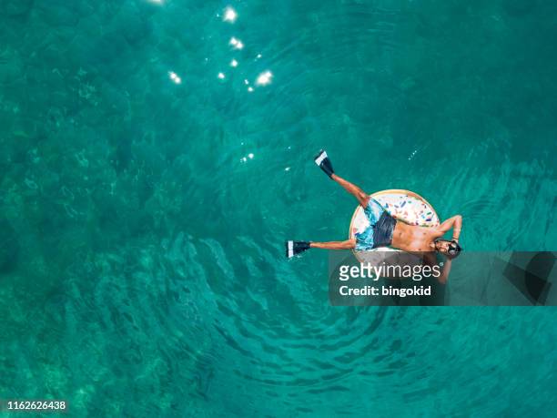 man resting on vacations - aerial beach view sunbathers stock pictures, royalty-free photos & images