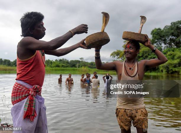 Snake Charmers and local villagers seen showing different tricks with the venomous Snake's during the Jhapan Festival of West Bengal. Jhapan Festival...