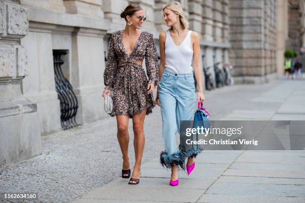 Ann-Kathrin Götze is seen wearing Zimermann dress with animal print, pouch and sandals Bottega Veneta, sunglasses Olivers People x The Row, earrings...