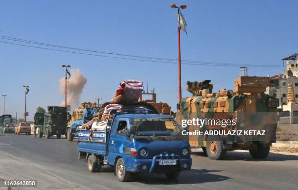 Convoy of Turkish military vehicles passes through Maaret al-Numan in Syria's northern province of Idlib reportedly heading toward the town of Khan...