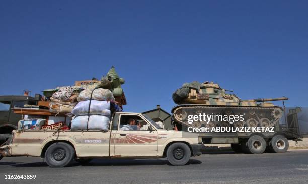 Convoy of Turkish military vehicles passes through Maaret al-Numan in Syria's northern province of Idlib reportedly heading toward the town of Khan...