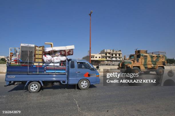 Convoy of Turkish military vehicles passes through Maaret al-Numan in Syria's northern province of Idlib reportedly heading toward the town of Khan...