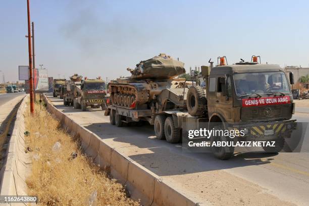 Convoy of Turkish military vehicles passes through Maaret al-Numan in Syria's northern province of Idlib reportedly heading toward the town of Khan...