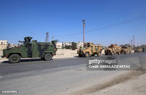 Convoy of Turkish military vehicles passes through Maaret al-Numan in Syria's northern province of Idlib reportedly heading toward the town of Khan...