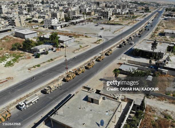 Picture taken on August 19, 2019 shows an aerial view of a convoy of Turkish military vehicles passing through Maaret al-Numan in Syria's northern...