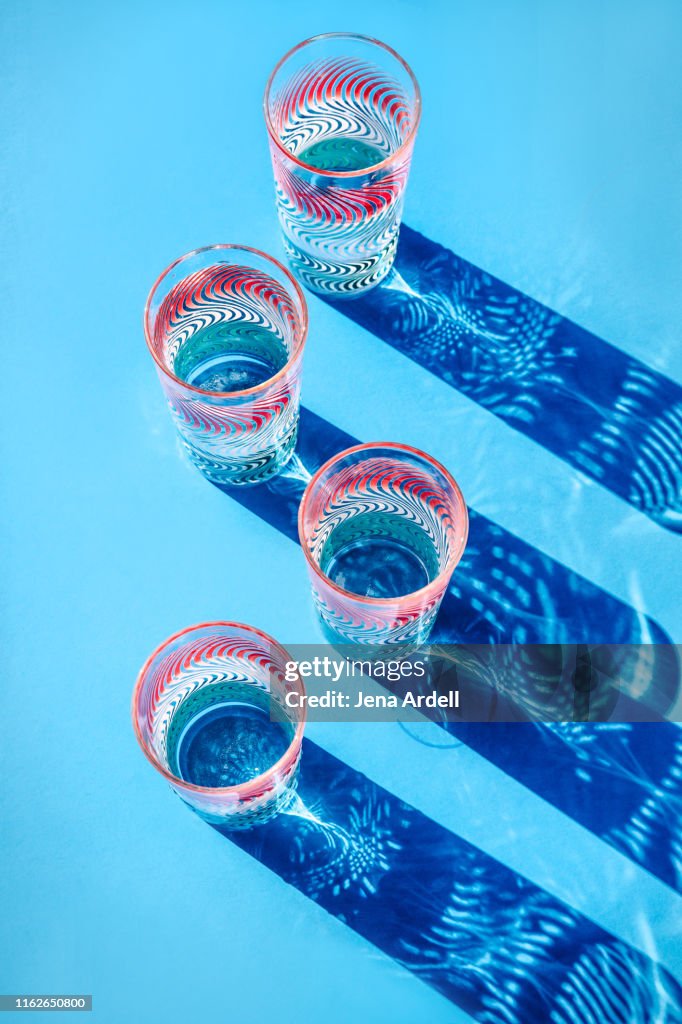 Colorful drinking glasses full of water, drinking glasses, still life, glasses of water, conceptual image for hydration