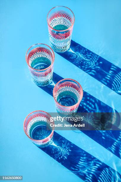 colorful drinking glasses full of water, drinking glasses, still life, glasses of water, conceptual image for hydration - old fashioned glass stock pictures, royalty-free photos & images