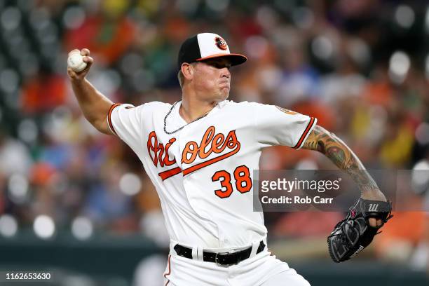 Starting pitcher Aaron Brooks of the Baltimore Orioles throws to a Washington Nationals batter in the first inning at Oriole Park at Camden Yards on...