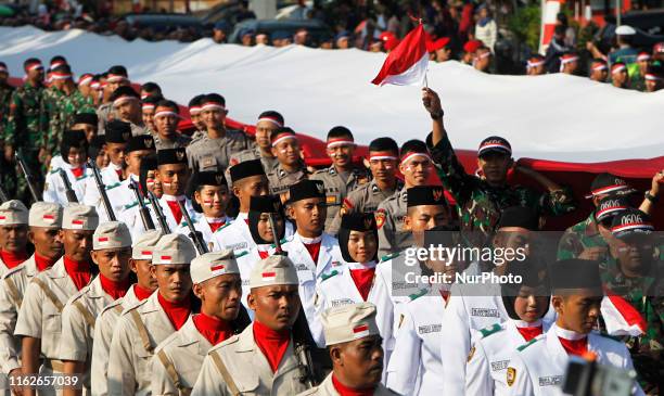 Number of Indonesian soldiers, Indonesian Police, and residents paraded the Indonesian giant flag in the city of Bogor, West Java, on Sunday, August...