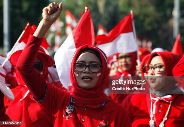 An Indonesian woman, seen following the Indonesian flag parade during celebration of the 74th commemorate of Indonesia's Independence day in the city...