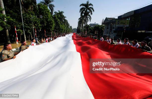 Number of Indonesian soldiers, Indonesian Police, and residents paraded the Indonesian giant flag in the city of Bogor, West Java, on Sunday, August...