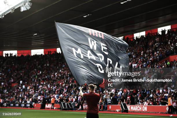 We march on flag waving ahead of the second half for the Premier League match between Southampton FC and Liverpool FC at St Mary's Stadium on August...