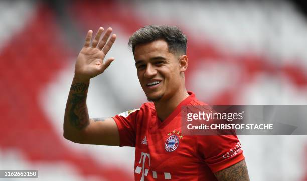 Brazilian midfielder Philippe Coutinho , new recruit of German first division Bundesliga football club FC Bayern Munich, waves during his...