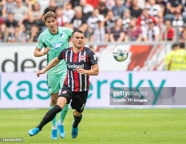 Robert Skov of TSG 1899 Hoffenheim and Filip Kostic of Eintracht Frankfurt battle for the ball during the Bundesliga match between Eintracht...