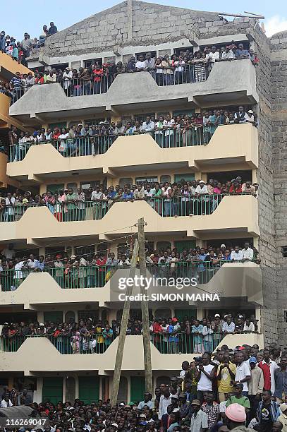Crowd watches rescue efforts after a building collapsed on June 14, 2011 in Nairobi. At least two workers were killed and 14 others are missing on...