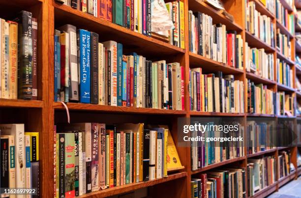 full bookshelves in a san fransisco bookstore - textbook stack stock pictures, royalty-free photos & images
