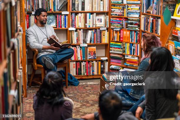 reading at a book group meeting - black authors stock pictures, royalty-free photos & images