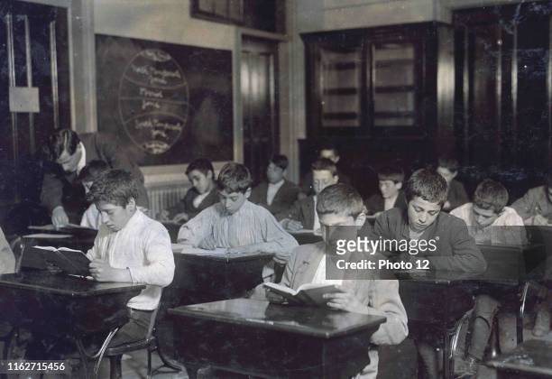 Image shows a class of immigrants in a night school in Boston, Massachusetts. C1909.