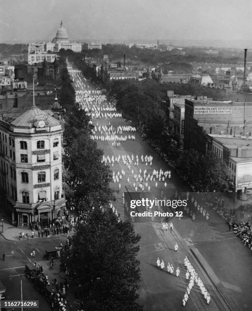 Photograph of a Ku Klux Klan parade on Pennsylvania Avenue, Washington D.C. With the U.S. Capitol Building in the background. Dated 1926.