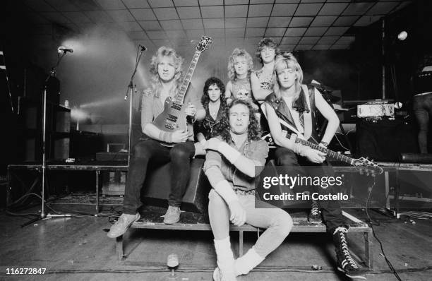 Statetrooper , British heavy metal band, pose for a group portrait, in October 1985. Two of the band members hold guitars as the band pose, on a...